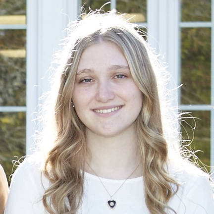 Smiling young woman with long, blond hair.